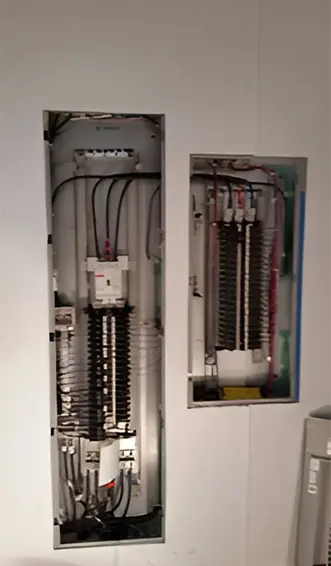 A view of an electrical panel and the inside of a room.