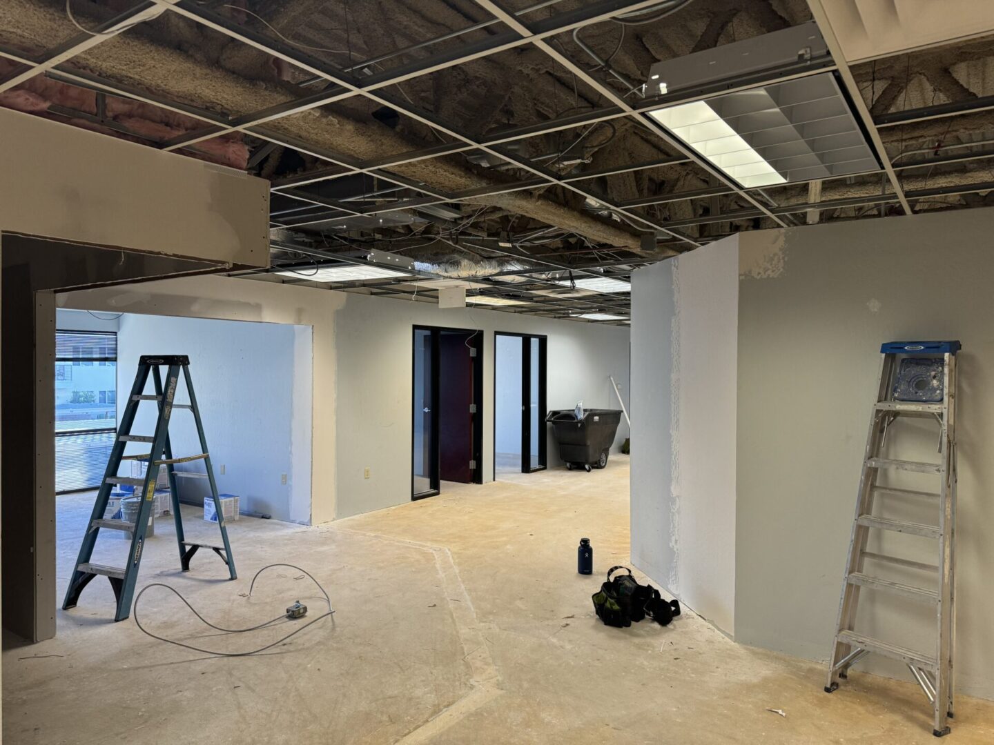 A room being remodeled with the ceiling removed.